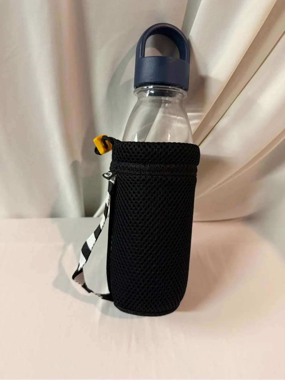 IKEA Clear Water Bottle with Blue Lid and Black Mesh Carrier